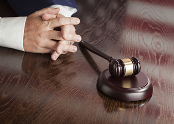 gavel and crossed fingers