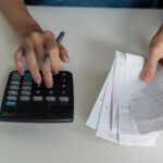 Budgeting and expense tracking concept image with receipts and a calculator, representing payday loan debt and bankruptcy relief in Florida