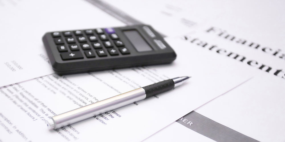 Financial statement review concept image with calculator and pen, representing private student loans and bankruptcy options in Florida.